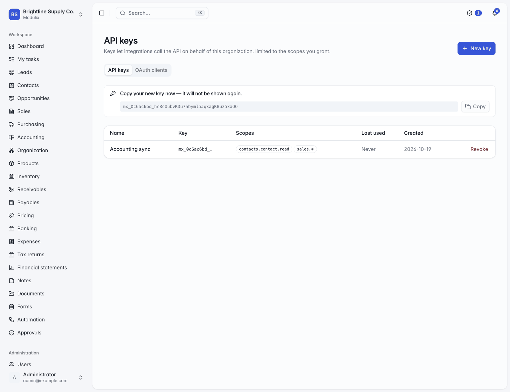 The API keys page with a newly created key shown once in a banner above the list of keys and their scopes
