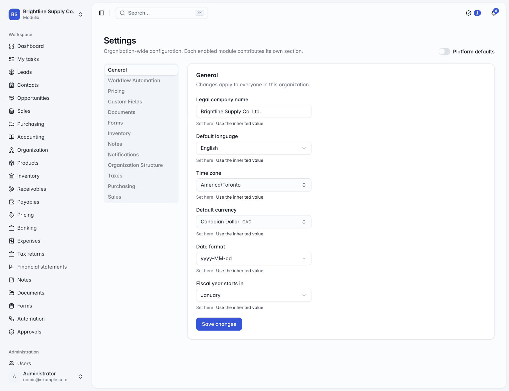 The Settings page with the General section selected, showing company name, language, time zone, currency, date format and fiscal year